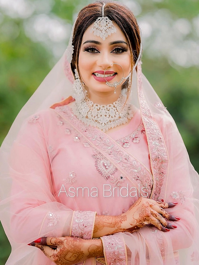 Bride in soft pink with detailed henna